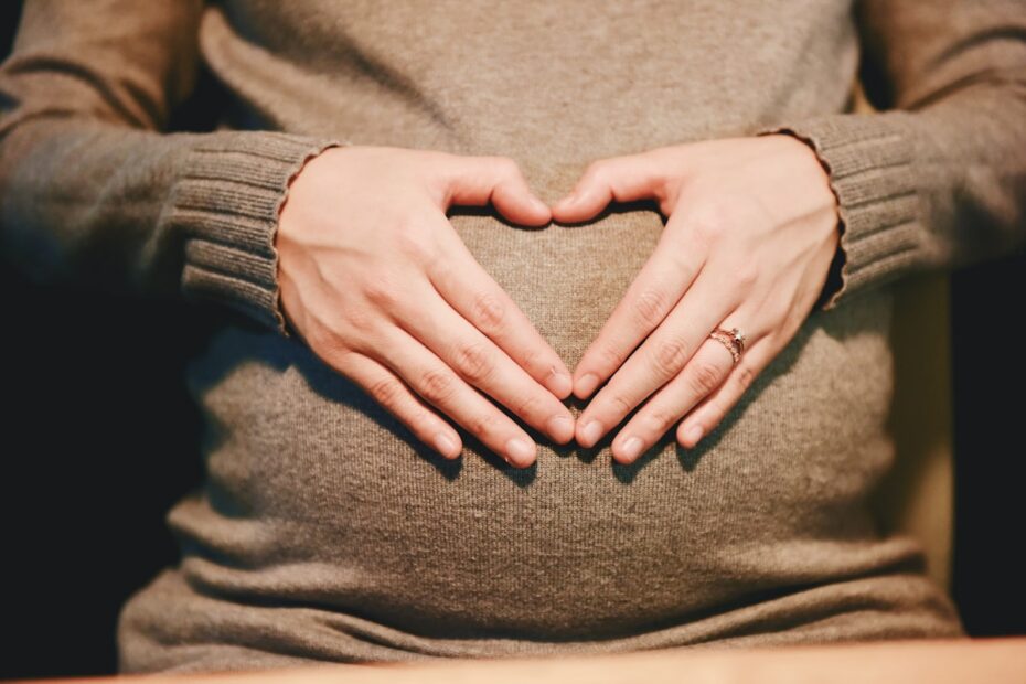 Pregnant person gently holding their belly, illustrating chiropractic care during pregnancy in Markham